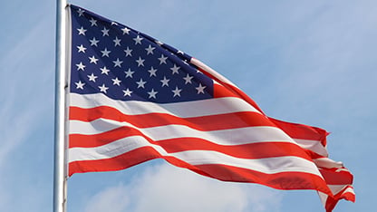 American flag with blue sky