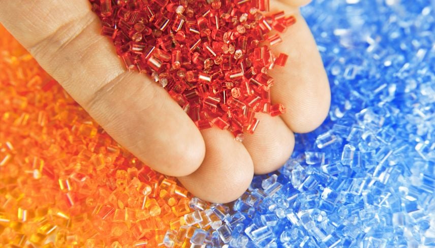 An individual presenting a collection of colorful plastic beads in their hand, highlighting the assortment of colors.