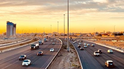 View of a bi-directional freeway with traffic moving both ways in a desert city setting